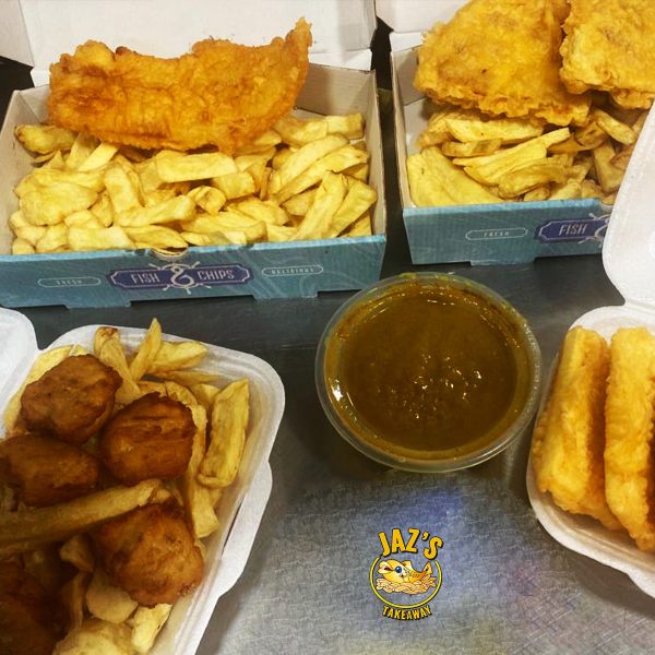 Multiple portions of fish, chips, nuggets, and a tub of curry sauce from Jaz's Takeaway in Crossgates